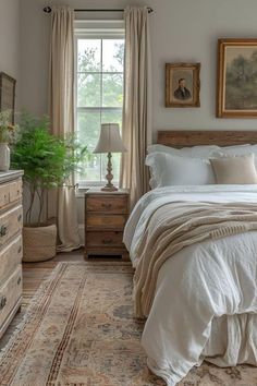 a bedroom with a bed, dresser and window in the corner next to a rug