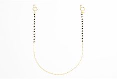 If you're looking for a subtle and classy piece, this chain is the one for you. The elegant gold loops and black spinal stone make for a delicate yet versatile combination. Whether you're going for a casual vibe or a fancy night out, this chain can be styled for any occasion. Minimalist Gold Body Chain, Elegant Black Body Chain For Party, Yellow Gold Jewelry With Chain Strap For Evening, Chic Beaded Chain Jewelry For Evening, Chic Evening Jewelry With Beaded Chain, Elegant Black Body Chain For Evening, Minimalist Jewelry With Adjustable Chain Strap, Adjustable Minimalist Jewelry With Chain Strap, Trendy Gold Body Chain With Delicate Details