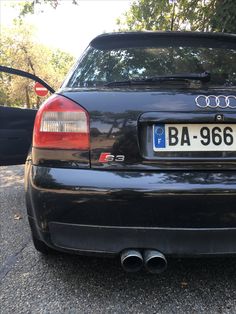 the back end of an audi car parked in a parking lot