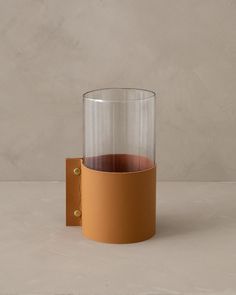 an empty glass with a brown leather holder