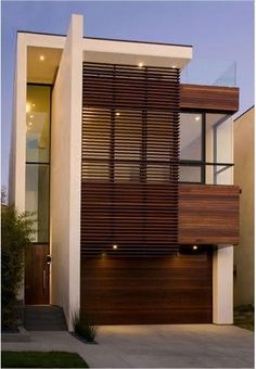 a modern house with wood slats on the side