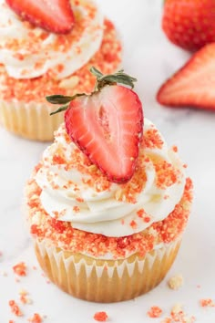 strawberry cupcakes with cream cheese frosting and sprinkles on top