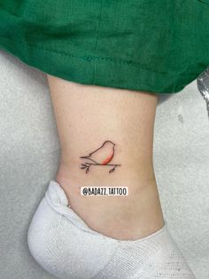 a small bird tattoo on the ankle