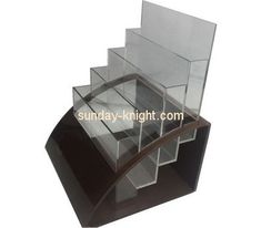 an acrylic display case with three sections and one section on the bottom shelf