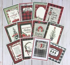 many christmas cards are arranged on a white table with red and green plaid designs,