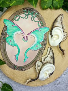 two butterflies are sitting on a plate next to some whipped cream and green leafy leaves