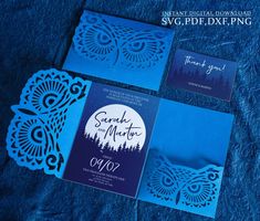 the wedding stationery is designed to look like an owl and has blue paper on it