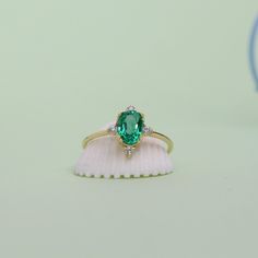 Gold Vintage Emerald Ring Oval Cut Green Gemstone Ring 14k Real Solid Gold Unique Design Statement & Anniversary Rings for Women with Yellow Rose White Gold Options ➤ Ring Details * 14k / 18k Yellow Gold  * Gold Color Options; 14K / 18k White, Yellow, Rose Gold * Band Width: 1.35 mm * Thickness: 1.35 mm ➤ Gem Details * Gemstone 1 : Emerald * Gem width: 5 millimeter * Gem length: 7 millimeter * Cut Type: Oval * Gemstone 2 : Moissanite * Gem width: 1.5x1.5 millimeter * Cut Type: Round * Ready to Ship 3-5 Business Days 💍 ISEA Jewels' pieces are handcrafted by 10-15 years of experienced craftsmen and made to order in a very short time. 🎁 All pieces come in a quality and hygienic suede gift box enclosed in a pouch. 🌎 Our products arrive worldwide within 6 working days. ❓ Questions, comments, Wedding Emerald Ring In Oval Cabochon Shape, Wedding Emerald Ring With Oval Cabochon, Oval Emerald Ring With Diamond Gemstone Accents, Oval Cluster Ring With Gemstone Accents For Gift, Emerald Oval Cabochon Gemstone Rings, Oval Emerald Ring In 14k Gold For Proposal, Formal Oval Emerald Ring With Gemstone Accents, Emerald Oval Cabochon Ring In Fine Jewelry Style, Formal Oval Cluster Ring With Gemstone Accents