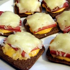 small sandwiches with cheese and meat on them