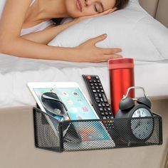 a woman laying in bed with her head resting on the pillow next to an alarm clock and remote control