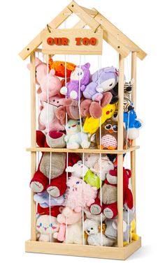 a wooden toy house filled with stuffed animals