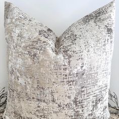 a decorative pillow on top of a bed