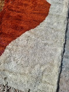 an orange and brown rug on the ground