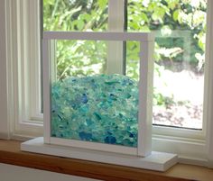 a window sill with sea glass in it