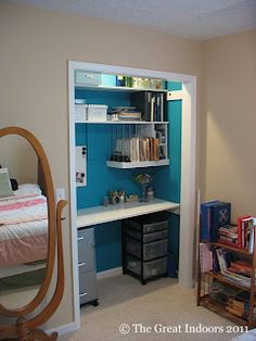 a bedroom with a bed, desk and bookshelf next to a mirror on the wall