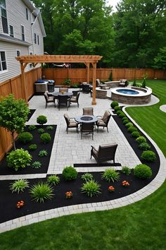 an outdoor patio with chairs, table and fire pit in the middle of grass area