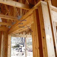 the inside of a house that is being built with wood framing and insulation tape on it