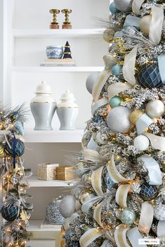 a decorated christmas tree with blue and silver ornaments