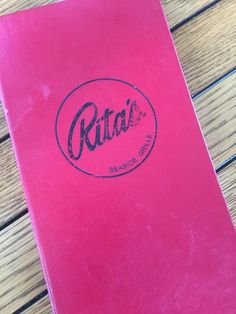 a pink book sitting on top of a wooden table