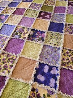 a quilted blanket with many different colors and designs on it's edges,