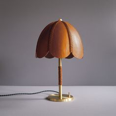 a lamp that is on top of a white surface with a cord in front of it