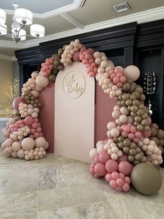 a balloon arch in the shape of a tree with balloons on it and a sign that says oh baby