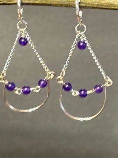 These are one of kind beautiful handmade purple amethyst chandelier dangle earrings. Artisan designed and handcrafted this unique structure.  Closing with sterling silver leverbacks, and hanging from a sterling silver chain. Total measurement is 2 1/2 inches long including sterling silver lever back earring wire. Purple Wire Wrapped Chandelier Earrings As A Gift, Purple Wire Wrapped Drop Earrings, Purple Wire Wrapped Chandelier Drop Earrings, Purple Dangle Earrings With Gemstone Beads, Handmade Purple Amethyst Chandelier Earrings, Amethyst Chandelier, Earring Wire, Purple Jade, Gift Jewelry