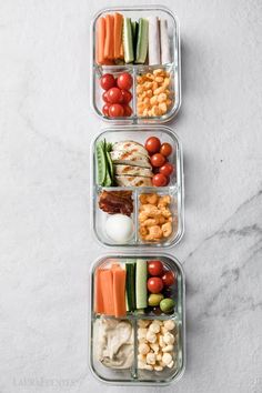 three plastic containers filled with different types of food on top of a marble countertop