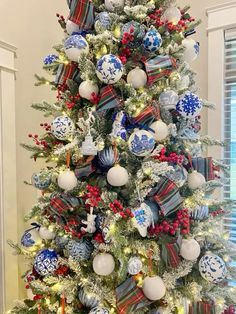 a decorated christmas tree with blue and white ornaments