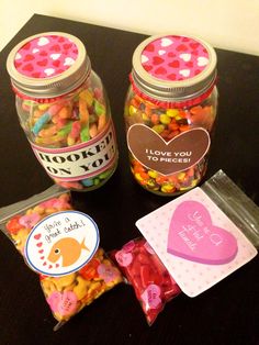 three jars filled with candy sitting on top of a table next to a card and envelope