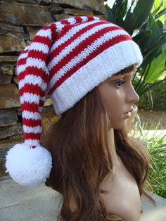 a mannequin head wearing a red and white knitted hat