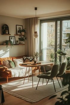 a living room filled with furniture next to a window covered in plants and potted plants