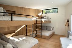 a bedroom with bunk beds and wooden walls