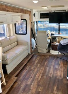 the inside of an rv with wood flooring