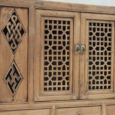 an old wooden cabinet with intricate carvings on the doors