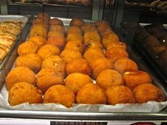 there are many different types of pastries in the display case