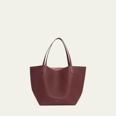 Mansur Gavriel tote bag in soft calf leather Flat shoulder straps  Open top with self-tie closure  Interior, leashed zip pouch bag Approx. 11.8"H x 21.5"W x 9"D Made in Italy Daily Use Smooth Grain Calf Leather Shoulder Bag, Daily Use Calf Leather Shoulder Bag With Smooth Grain, Smooth Grain Calf Leather Shoulder Bag For Daily Use, Calf Leather Bag With Double Handle For Daily Use, Calf Leather Double Handle Bag For Daily Use, Smooth Grain Crossbody Bag For Shopping, Everyday Leather Shoulder Bag With Handle Drop, Leather Bucket Bag With Handle Drop For Daily Use, Daily Use Calf Leather Shoulder Bag With Double Handle