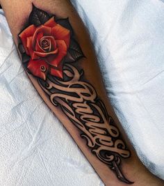 a rose with some writing on it is sitting on a person's leg and has the word love written in cursive font