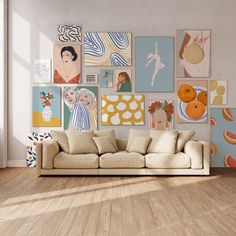 a living room filled with lots of art on the wall above a beige couch and wooden floor