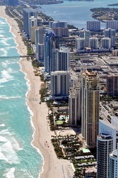 an aerial view of the beach and ocean in miami, florida with high rise buildings