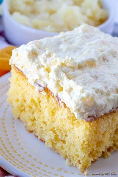 a close up of a piece of cake on a plate with other food in the background