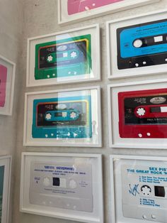 there are many cassettes on the wall with different colors and designs around them,