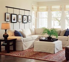 a living room filled with furniture and pictures on the wall