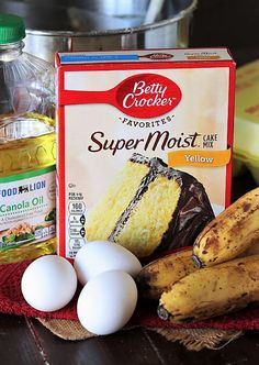 ingredients for cake sitting on a table next to an egg carton and banana peel