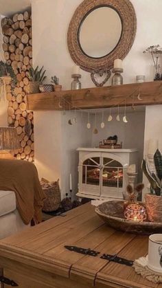 a living room filled with furniture and a fire place next to a mirror on the wall