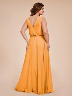 a woman in a yellow dress with her back to the camera