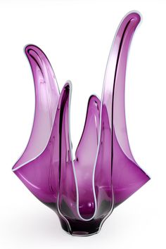 a purple vase sitting on top of a white table