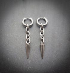 Stunning silver spike and chain link earrings! Unisex. Sold as a pair  Made of high quality stainless steel. Also available in gold! Spike measures 21mm hoops measure 15mm  Please don't hesitate to contact me with any queries or suggestions 😊  Comes gift wrapped 💜 Modern Silver Metal Piercings, Edgy Silver Metal Piercings, Minimalist Silver Metal Piercings, Silver Metal Dangle Piercings, Silver Dangle Metal Piercings, Silver Dangle Stainless Steel Piercings, Silver Stainless Steel Dangle Piercings, Silver Stainless Steel Dangle Cartilage Earrings, Edgy Silver Stainless Steel Earrings