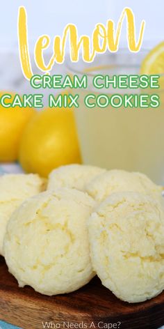 lemon cream cheese cake mix cookies on a cutting board with lemons in the background