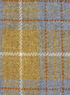 an image of a checkered fabric pattern in yellow, blue and grey colors photo